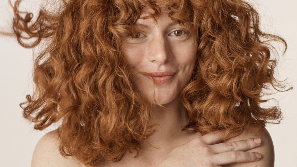 Close-up of woman with red curly hair