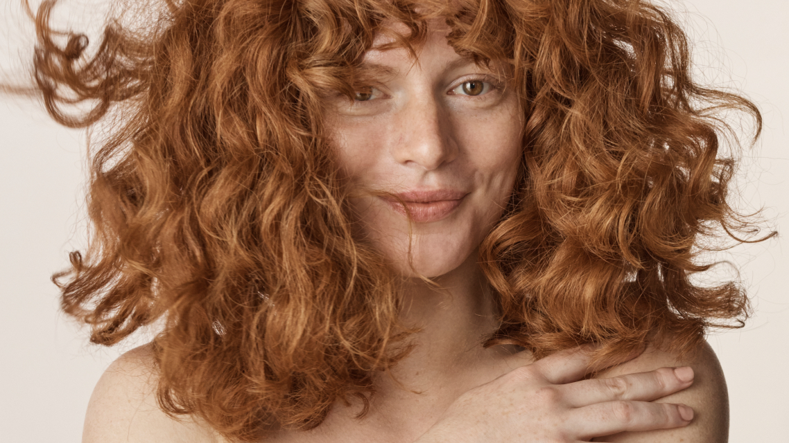 Close-up of woman with curly, red hair