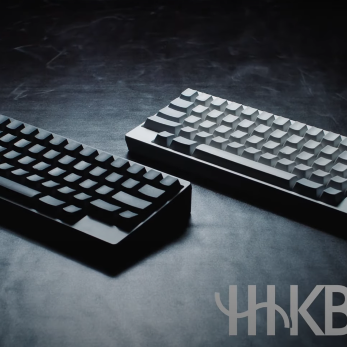 Two Happy hacking keyboards in white and black