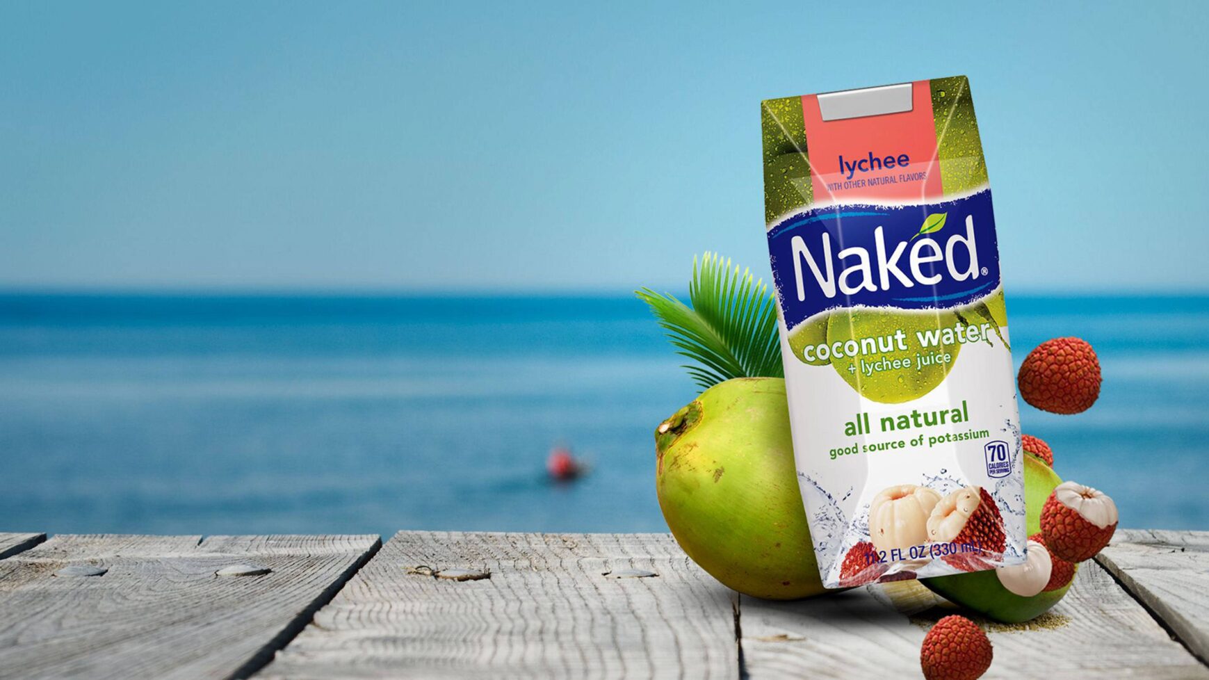 Naked Coconut Water on a dock by the water