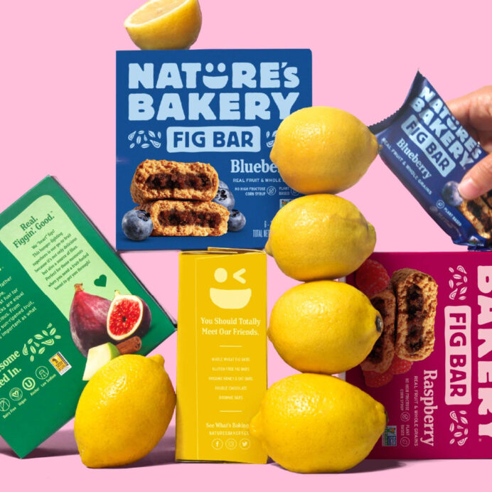 Boxes of Nature's Bakery bars stacked on top of each other with lemons beside them