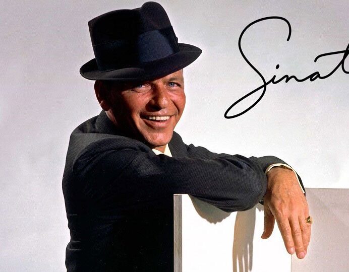 Frank Sinatra smiling with his name signed next to him