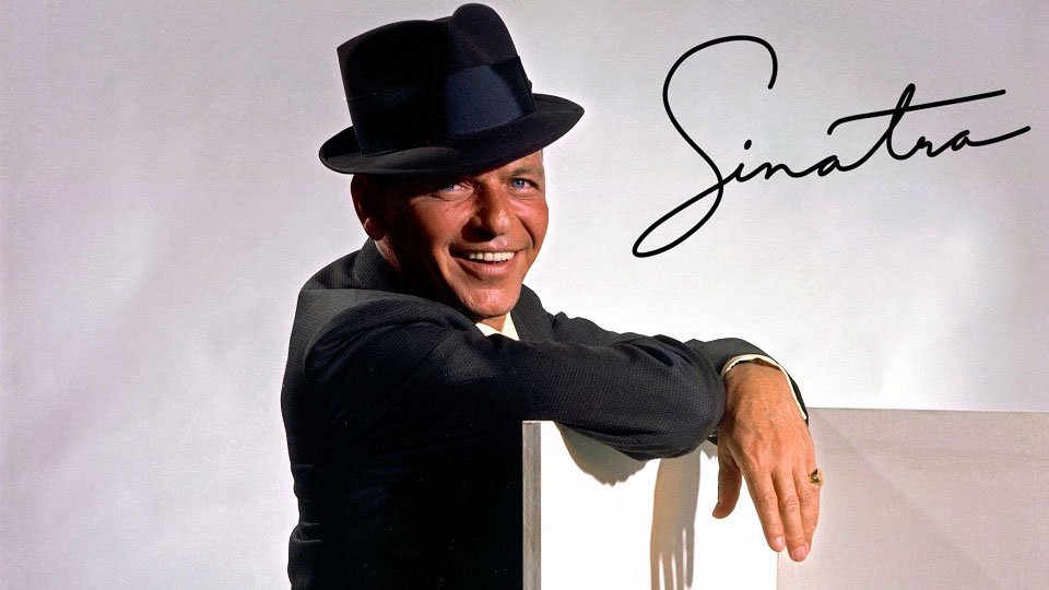 Frank Sinatra smiling with his name signed next to him