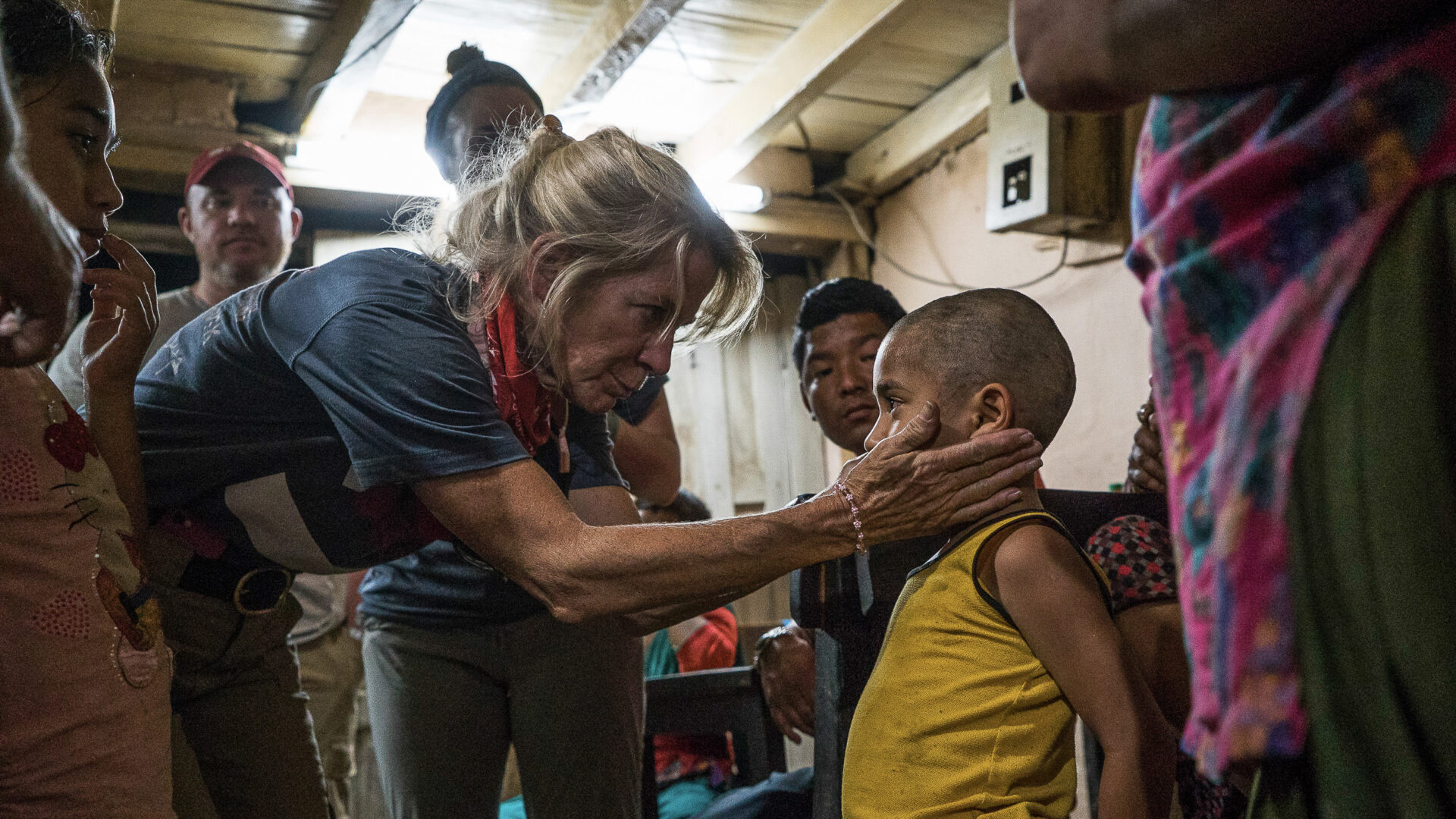Team Rubicon member helping a child