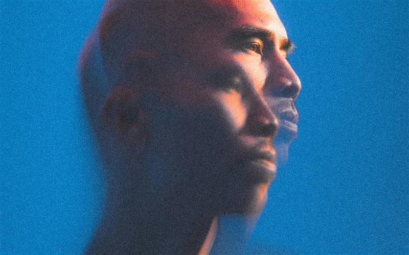 Abstract double-exposure portrait of a person against a blue background