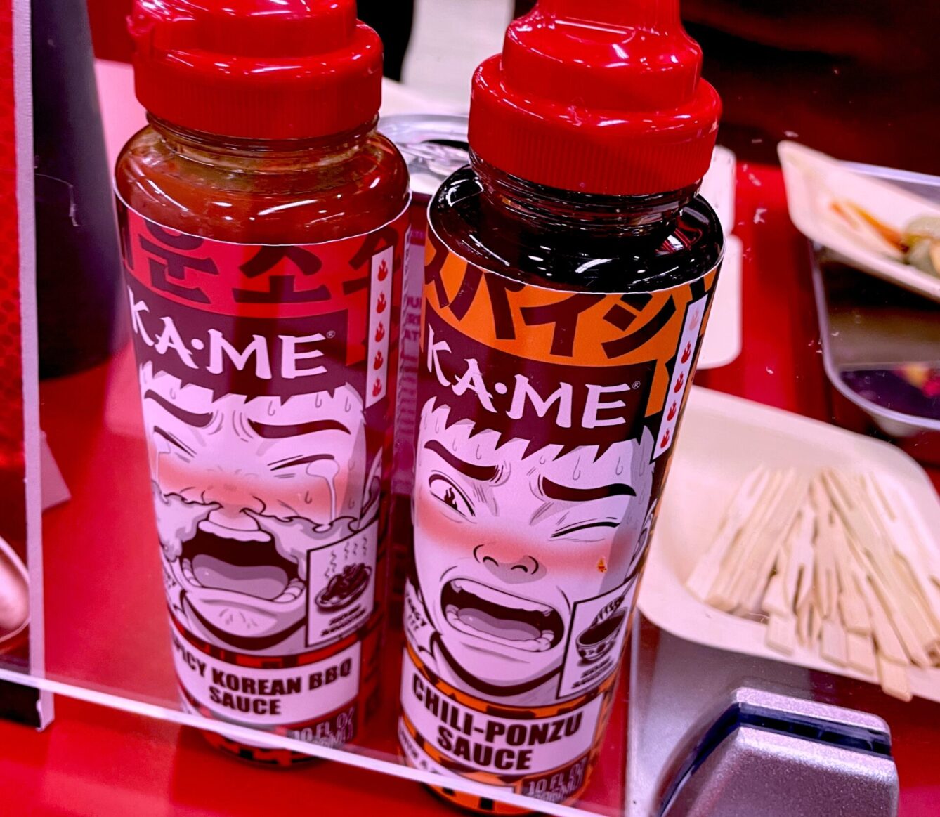 Two hot sauces on a counter displaying Korean-infused flavors