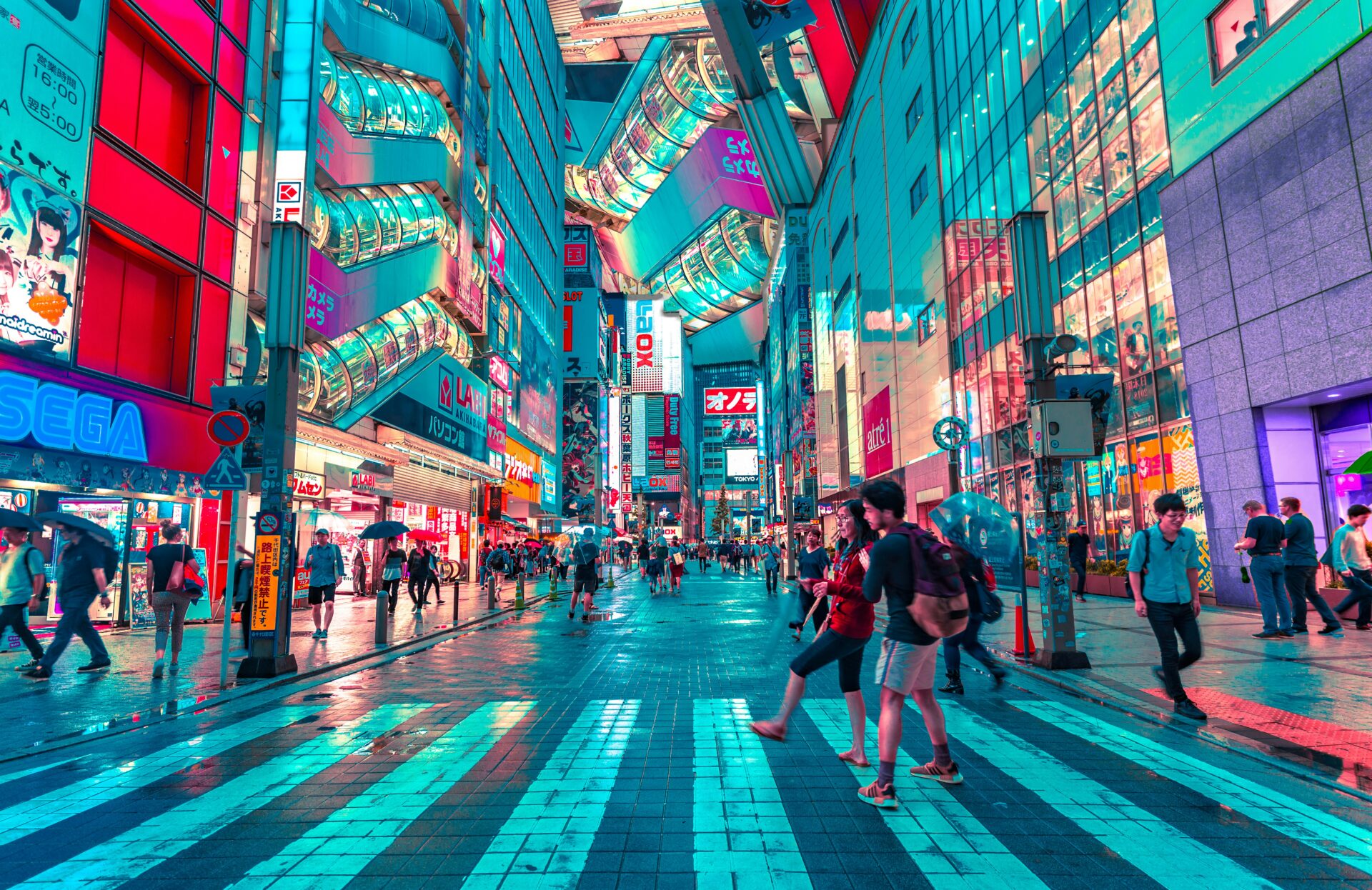 Busy image of bustling city intersection with massive amounts of neon signs giving the image a cyan tinge